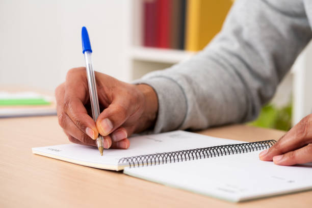istock black man writing on paper agenda 1469734714