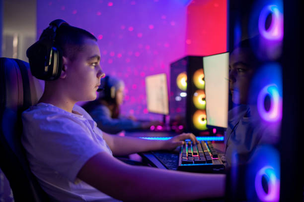 istock Friends playing video games on a computer for a tournament. 1469735059