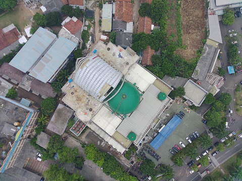 aerial view of the Darusalam mosque on the side of the highway.