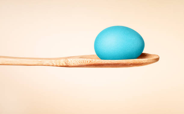istock Easter eggs dyed, painted inbright blue color on wooden spoon for spring religious holiday 1469735862