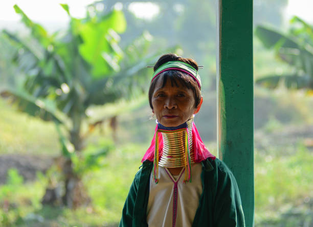 Inle Lake, Myanmar - Feb 15, 2016. A Kayan woman (Long Neck People) weaving silk fabric on a wooden loom in Inle Lake, Myanmar.