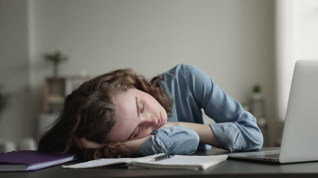 Woman falls asleep, feels exhaustion during making bored job