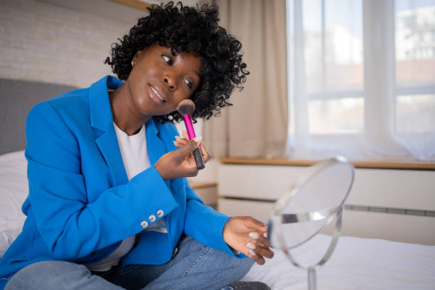 istock Woman applying moisturizer on face 1469743896