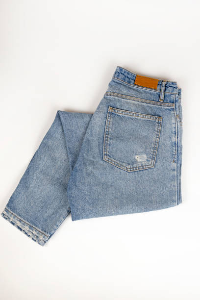 istock Folded blue jeans on a white background, top view. Close up. 1469744454