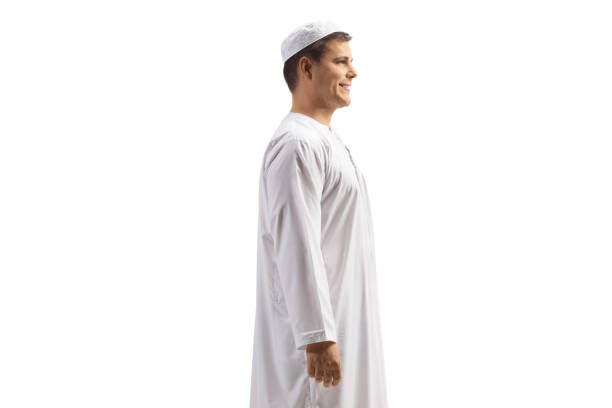 Profile shot of a young man in white ethnic clothes isolated on white background
