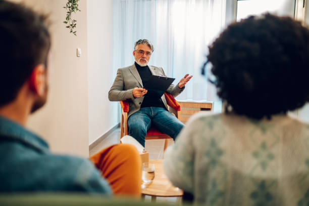 istock Senior man psychiatrist talking with his patients during therapy session 1469747426