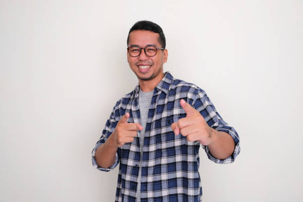 istock Adult Asian man smiling happy while pointing to the camera 1469751164