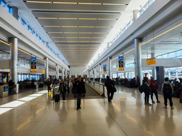 People walking and standing in the newly competed A gate concourse at Denver International Airport. stock photo