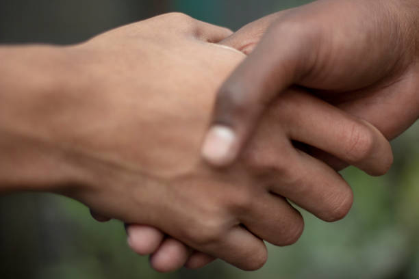 istock there is two man shake their own hand with one another and the background is blurred 1469753444