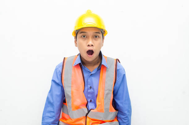 istock asian construction worker wearing yellow safety helmet shouting with shocked and surprised expression. 1469754621