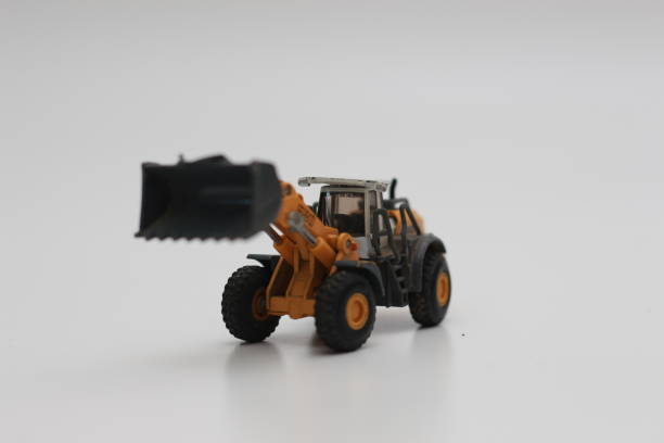 istock a close up of miniature orange wheel loader toy 1469754624