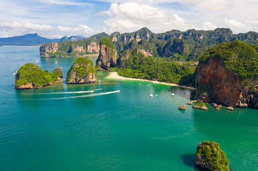 ao nang and rai lay with pranang beach and long tail speedboat passengers tourist in high season at kra bi Thailand aerial landscape view