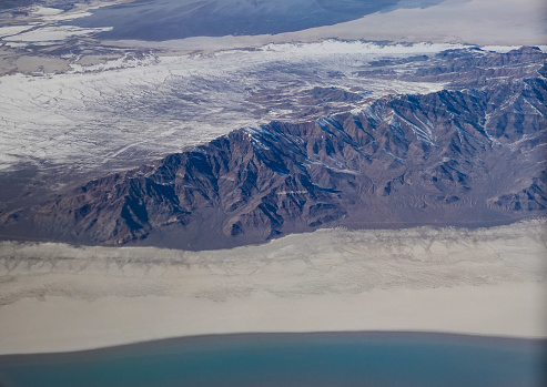 Aerial view of the shrinking Great Salt Lake with islands and salt flats in winter.