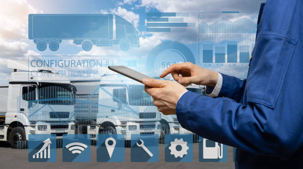 istock Manager with a digital tablet on the background of trucks 1469756802