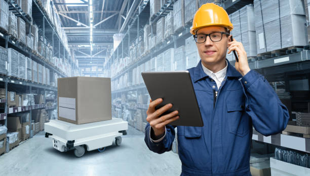 istock Manager with digital tablet and phone in an automated warehouse 1469758313