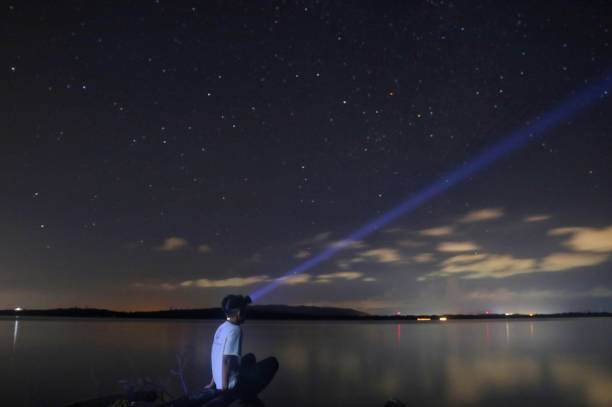 istock Stars at Night and a man with a flashlight on his head 1469759080
