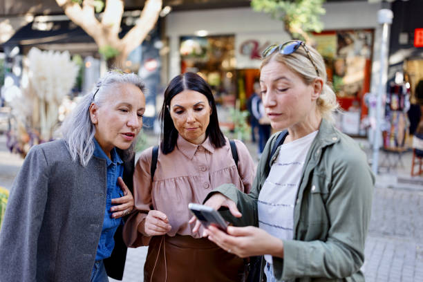 istock Friends looking for direction on their phone 1469759388