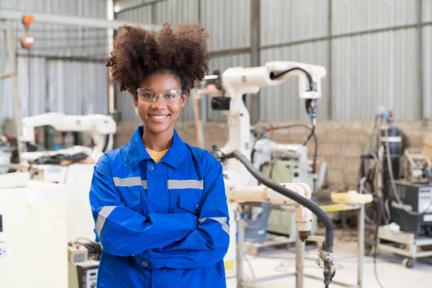 istock Engineer female worker at work in the industry factory, work with robot arm welding machine at production line 1469759771