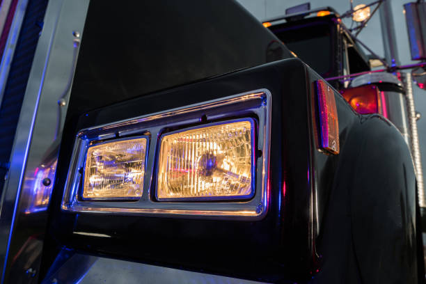 istock Classic Black Semi Truck Tractor Headlight Close Up 1469759851