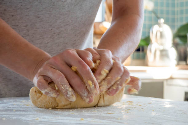 istock Woman kneading dough on kitchen counter 1469760601
