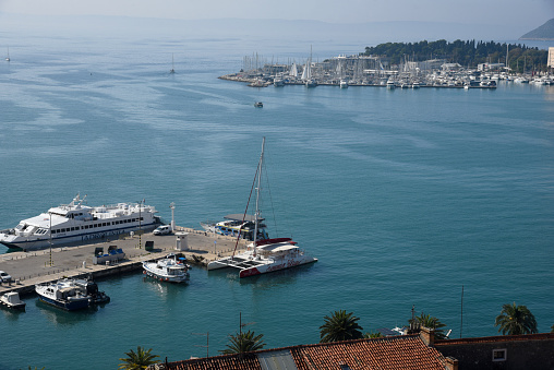 Embankment, sea and cityscape view from above. Split in autumn, sunny day, many tourists. Split, Croatia.  October 17, 2022