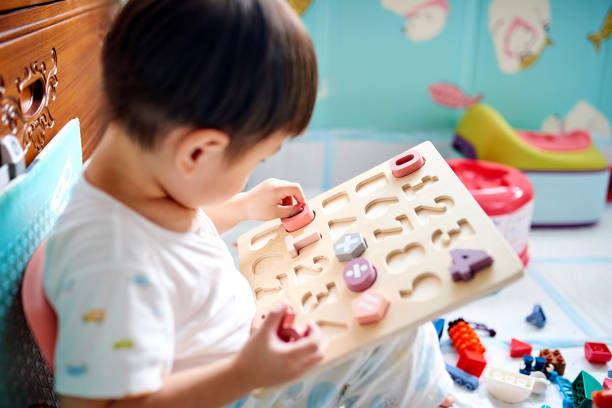 istock Little Boy Playing with Numbers Toy Puzzle 1469765991