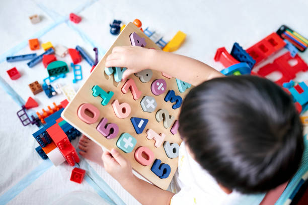 Little Boy Playing with Numbers Toy Puzzle