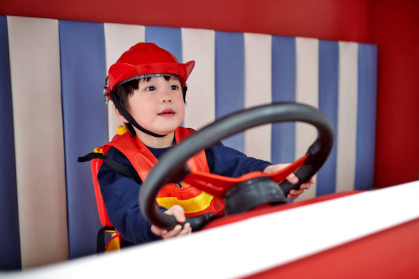 istock Children Imitation Firefighter Driving Fire-Truck 1469766023
