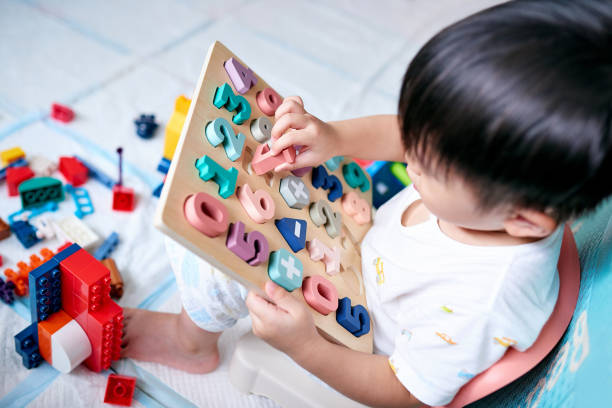 istock Little Boy Playing with Numbers Toy Puzzle 1469766032
