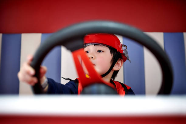istock Children Imitation Firefighter Driving Fire-Truck 1469766069