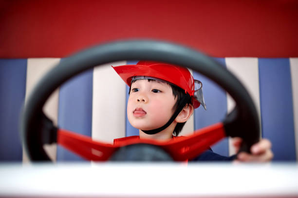 Children Imitation Firefighter Driving Fire-Truck stock photo