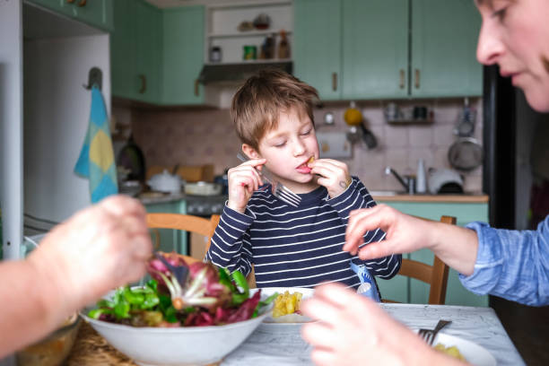 istock Kid having a lunch with his mother 1469768536