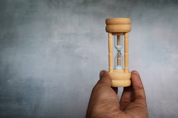 istock Closeup image of hand holding sand hourglass with copy space 1469770137