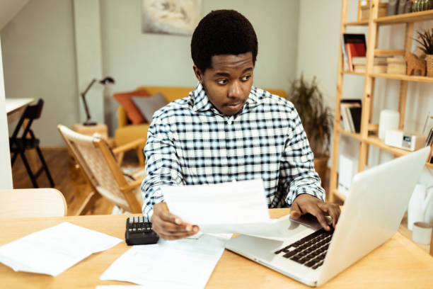 istock Young African American managing expanses at home 1469770244