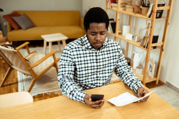 istock Young African American having problems with his monthly finances 1469770246