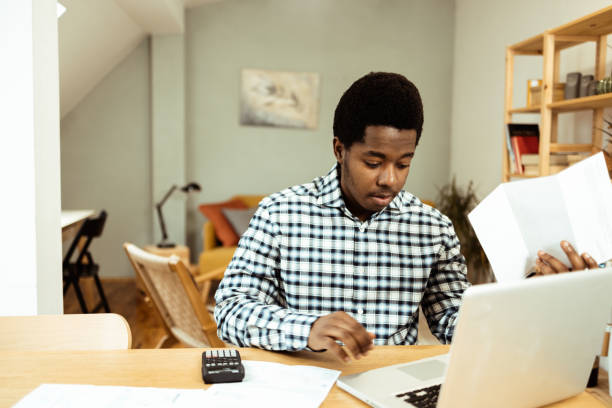 istock Young African American planning his finances at home 1469770268