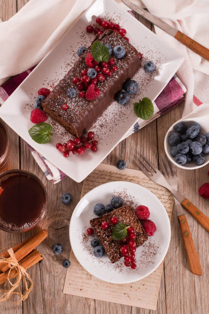 istock Chocolate sponge cake with fresh fruit on white dish. 1469770725