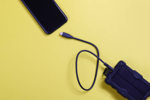 istock cheapest source of electricity. power box, portable solar battery for phone on yellow background. innovative solutions concept. copy space 1469773398