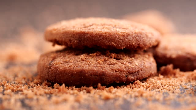 Extreme close-up Cookies, Chocolate chip cookies dropping, falling into table, slow motion. Concept of Dessert, Snack, Biscuit, Chocolate Cookies, Bakery, American Food, Unhealthy Food