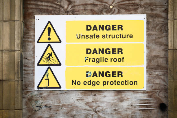 istock Unstable building keep out dangerous sign on fence at building construction site 1469777368