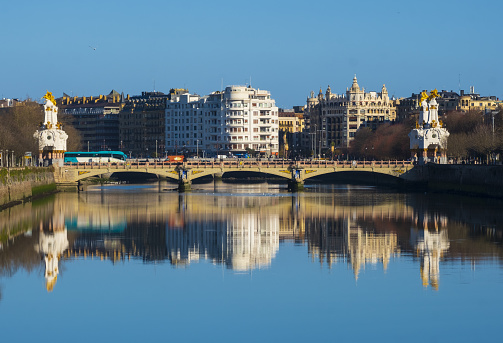 Buildings of the city of Donostia-San Sebastian are reflected in the Urumea river.