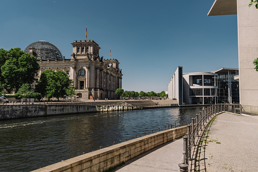 The cityscape of Berlin includes the Spree River, which runs near the Reichstag building and the modern Government office.