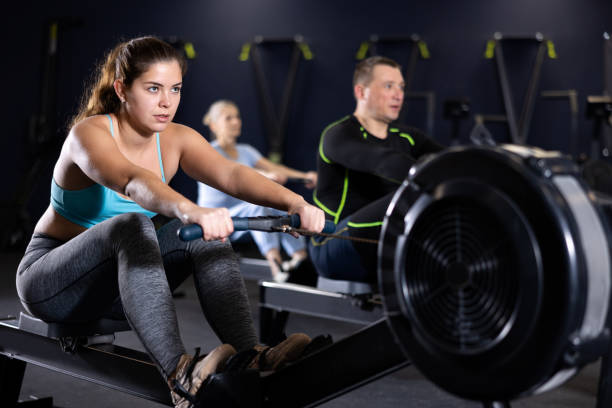 istock Sporty young woman using cable row machine in gym 1469781192