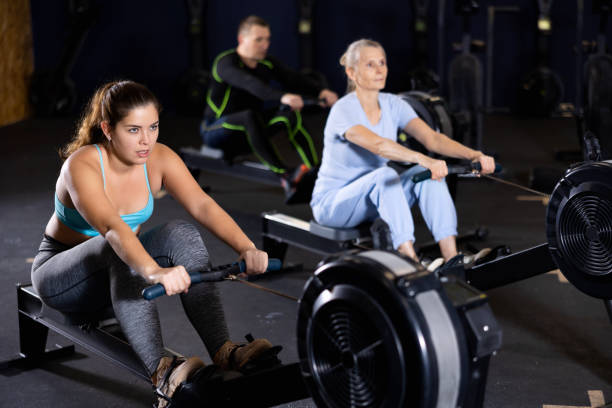 istock Athlete woman works on rowing simulator in gym 1469781194