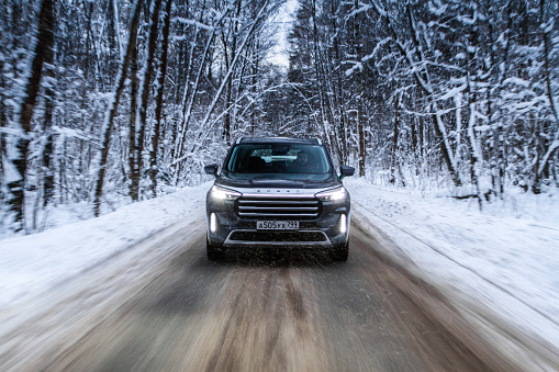 Moscow, Russia - December 18, 2021 Exeed VX also called Lanyue, midsize crossover car. Exterior front-side view on winter background. Exeed VX in motion.
