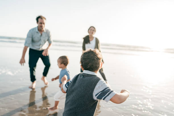 istock Parents playing with kids on the beach 1469785119