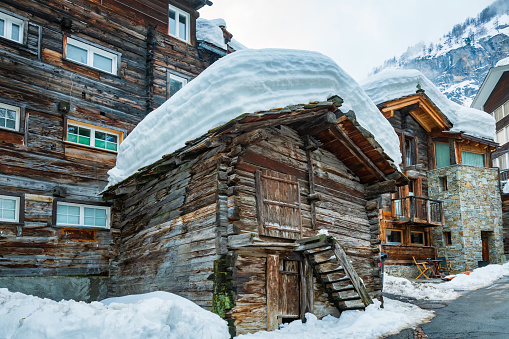 Detail of old tough timber house in the old part of Zermatt town, known as the Hinterdorf (rear village), Mattertal, Valais canton, Switzerland, in winter. Some are built up even four centuries ago. Taken by Sony a7R II, 42 Mpix.