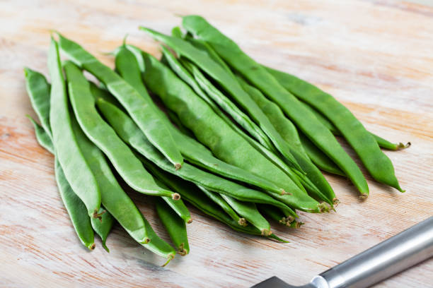 istock Green beans on wooden table 1469786662