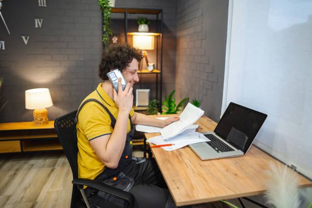 istock Craftsman calling colleague on the phone asking for instructions 1469787313