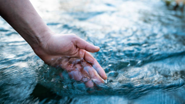 istock A female hand touching the river water 1469788037